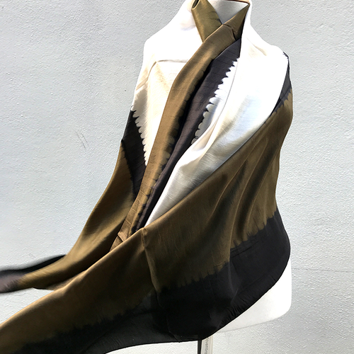 Silk scarf on manequin blowing in breeze. Scarf is coffee, dark brown and white colours. Large blocks of colour. 
