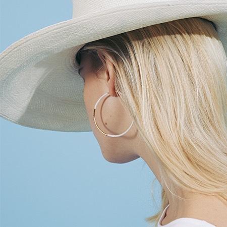 White sun hat with gold hoop earing