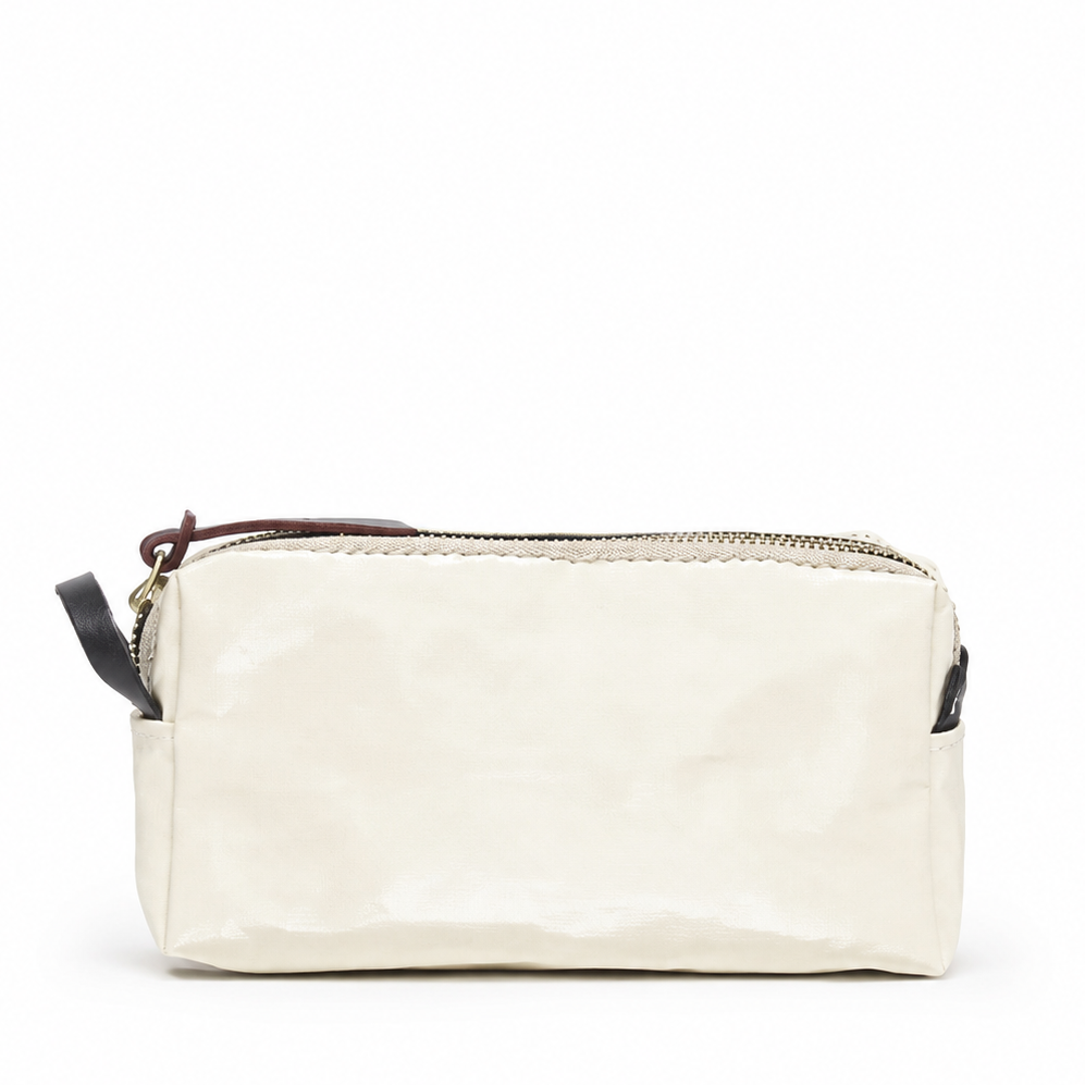 An off-white crinkled leather cosmetic pouch with a gold zipper, a dark brown leather pull tab, and a black wristlet strap, shown against a plain white background.