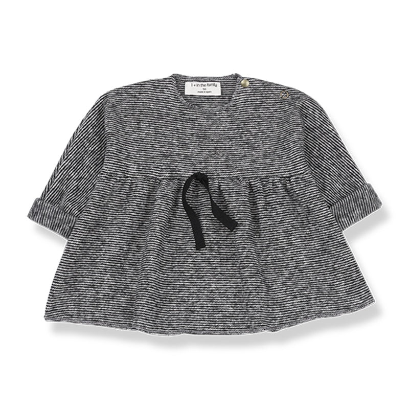 Black and white baby top/dress with black ribbon in middle front view