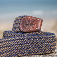 Closeup detail of woven belt on a rock at the beach