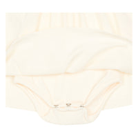 White long organic cotton baby dress underneath view dome buttons