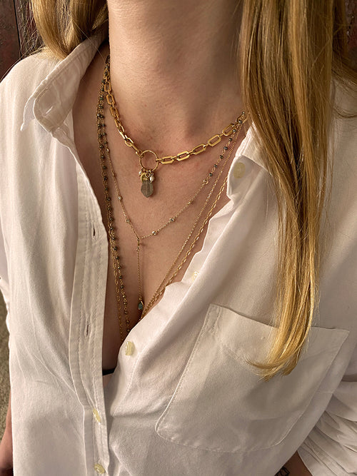Layered Hanka In necklaces gold silver and precious stones on model.