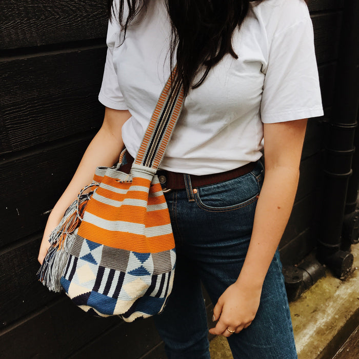 Handmade handbag over shoulder strap in blue white black and orange pattern 