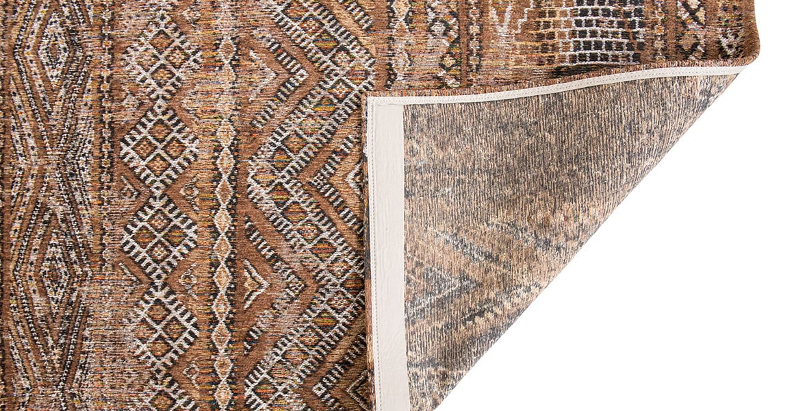 Underside of Earth tones moroccan nomad pattern rug. 