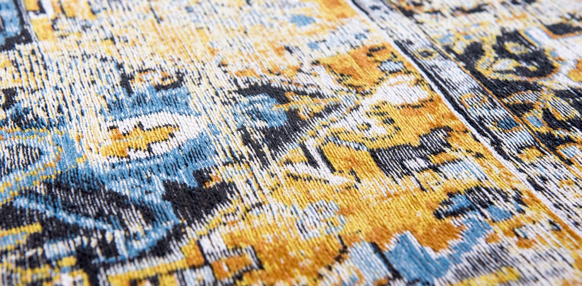 close up of organge and boue detail on rug