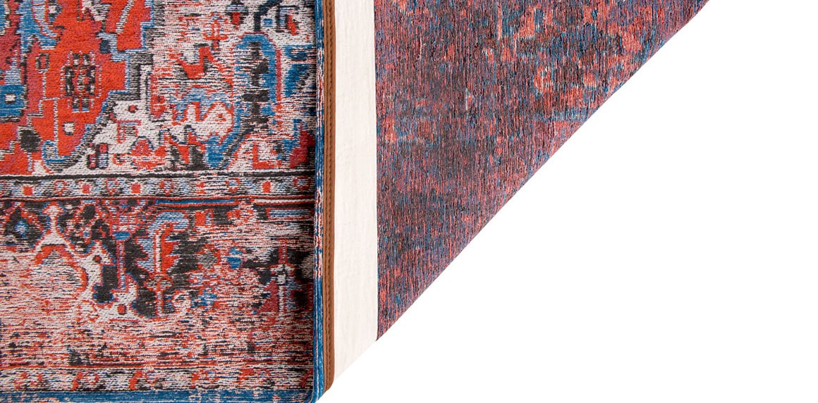underside view of faded rug in red tones 