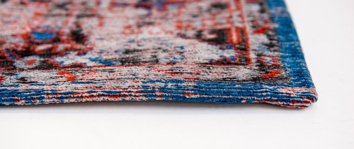 close up of the edge of rug, blue border with red