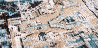 closeup of beige detail on pale faded rug