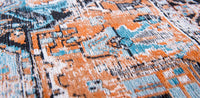 Orange and blue detail on faded rug