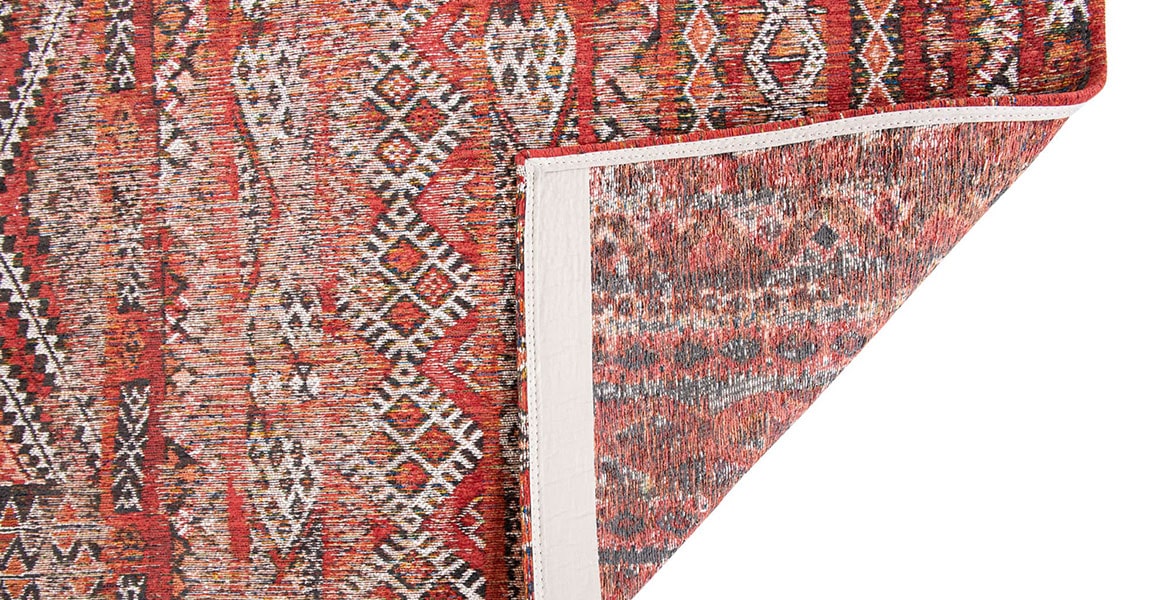Underside of rug with Morrocan nomad pattern in red tones.