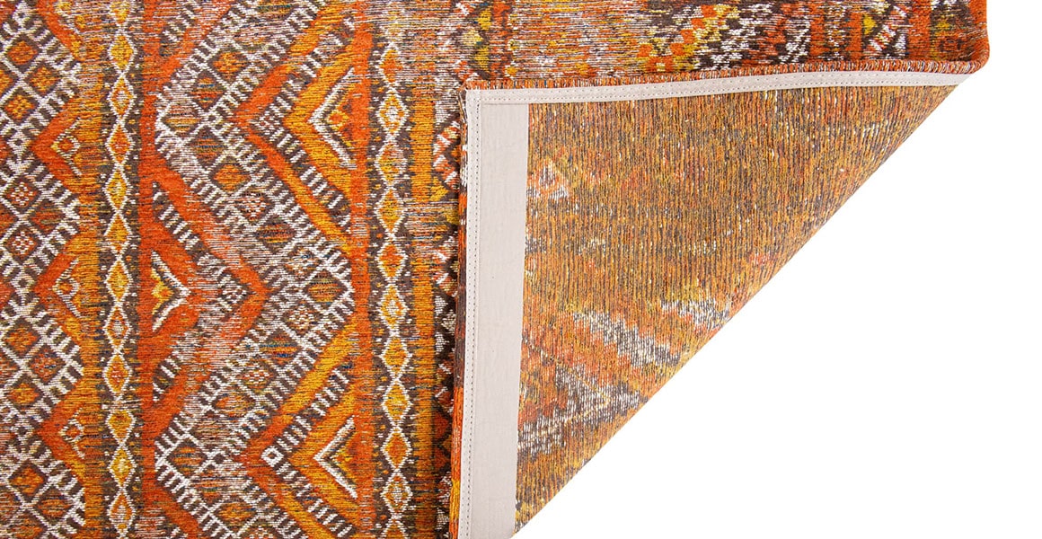 Underside view of rug with Morrocan nomad pattern in orange tones.