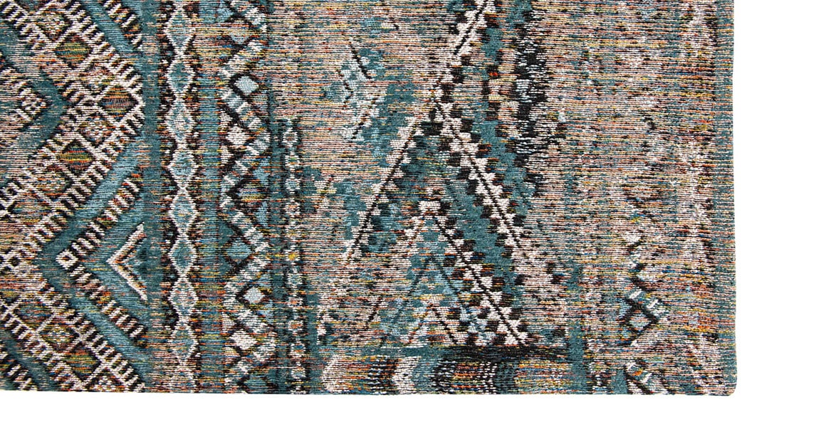 Corner view of rug with Morrocan nomad pattern in blue tones.
