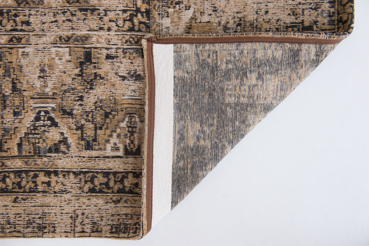 Underside view of warm beige distressed rug