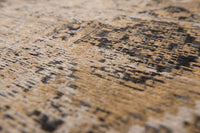 Closeup woven detail of warm beige distressed rug
