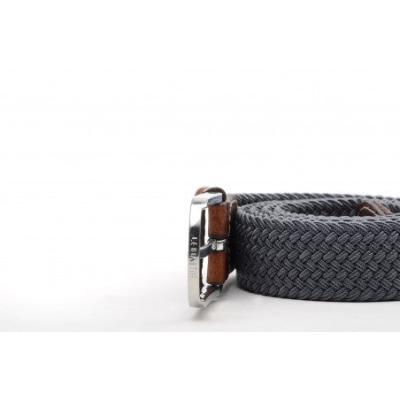 Elastic braided belt in dark grey, with brown leather finish against white background with silver buckle