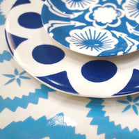 Blue and white kashgar dinner plate on table, close up.