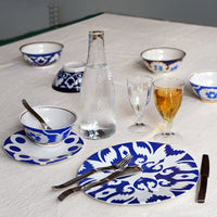 Blue and white kashgar dinner plates on table, with other kashgar tableware.