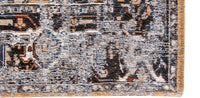 closeup view of faded rug in pale tones and white with brown detail